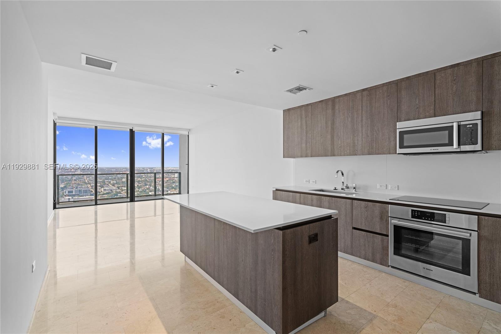 88 Southwest 7th Street, Unit 3608 Miami, FL 33130 - Photo 2 of 36 a kitchen with stainless steel appliances a stove sink and cabinets