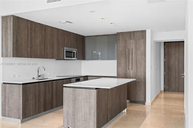 a kitchen with a sink and a refrigerator