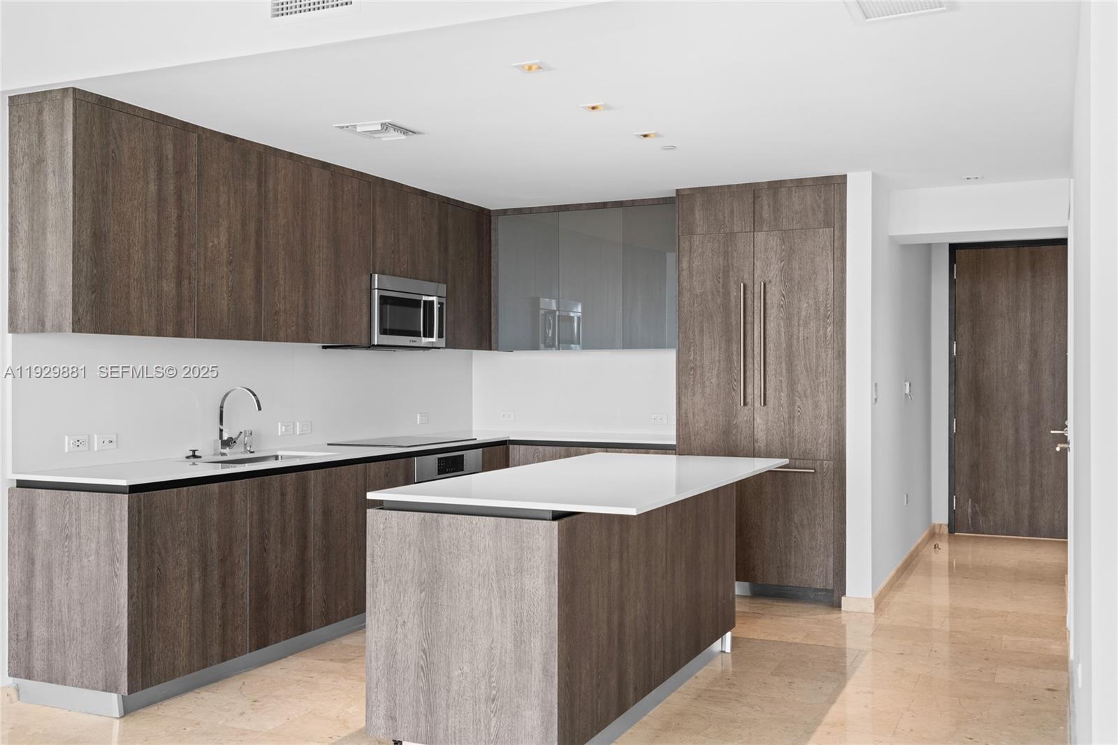 88 Southwest 7th Street, Unit 3608 Miami, FL 33130 - Photo 22 of 36 a kitchen with a sink and a refrigerator