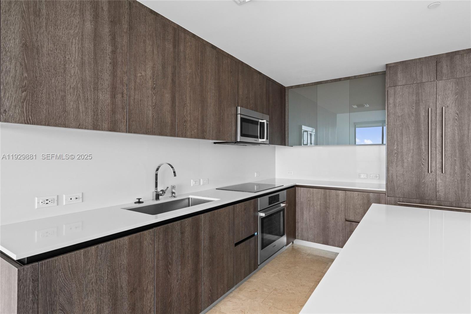 88 Southwest 7th Street, Unit 3608 Miami, FL 33130 - Photo 30 of 36 a kitchen with a sink and cabinets