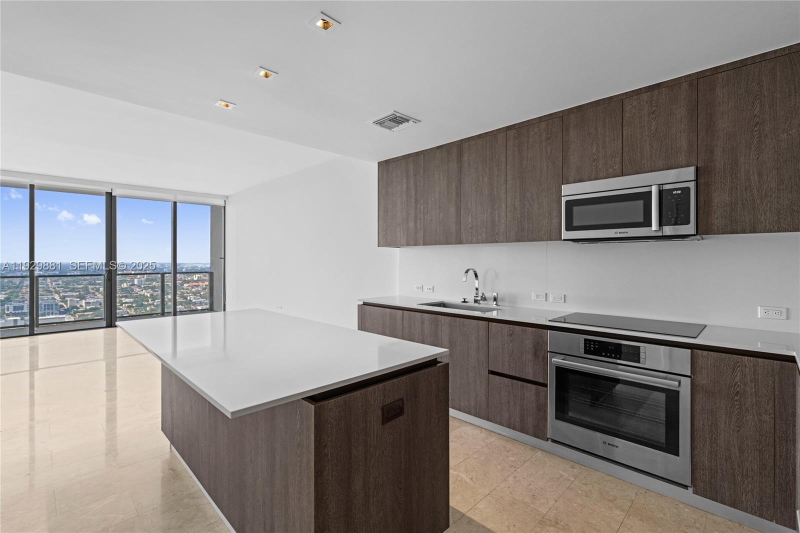88 Southwest 7th Street, Unit 3608 Miami, FL 33130 - Photo 35 of 36 a kitchen with a stove and a microwave