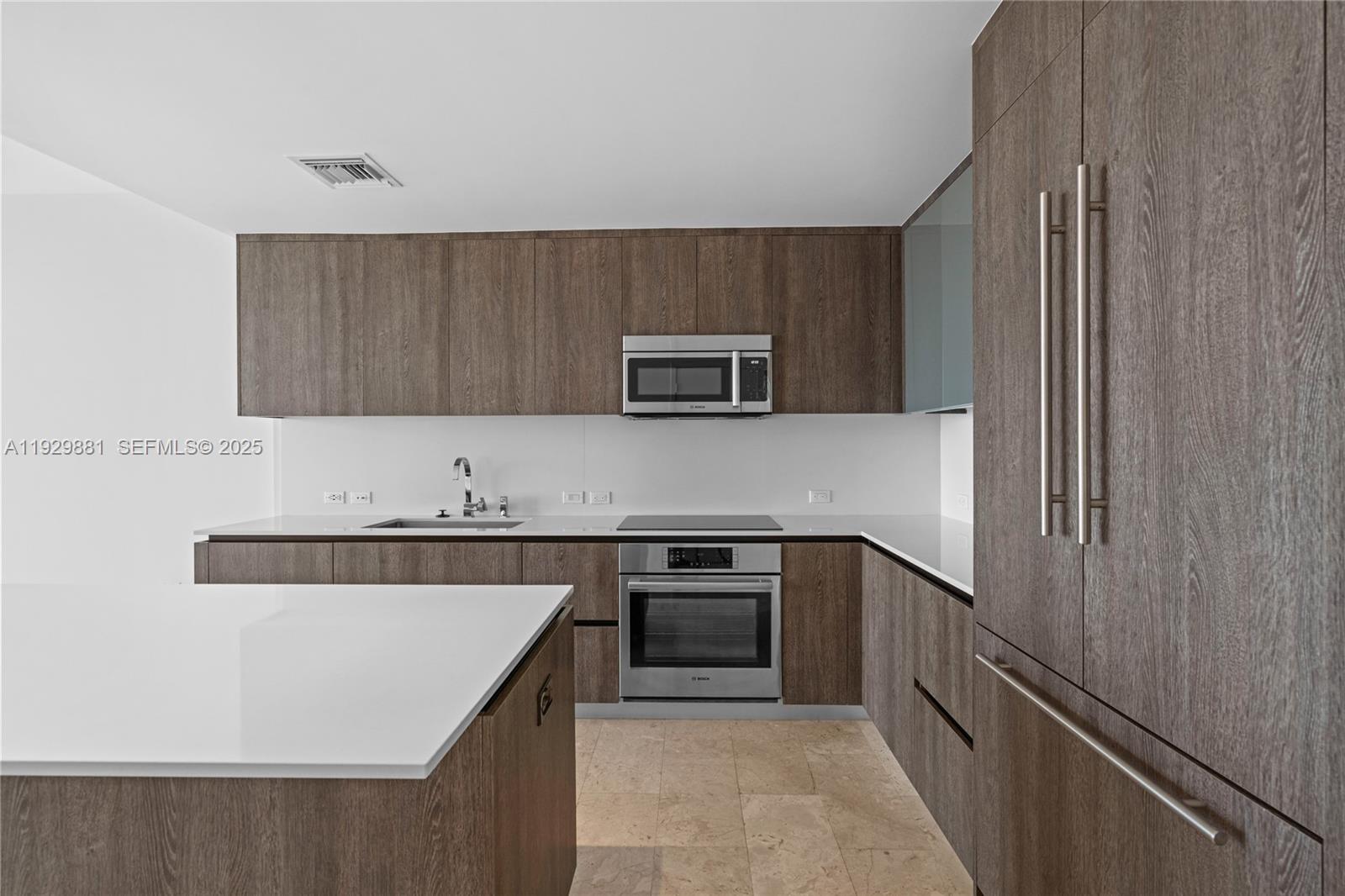 88 Southwest 7th Street, Unit 3608 Miami, FL 33130 - Photo 36 of 36 a kitchen with stainless steel appliances granite countertop a stove a sink and a microwave