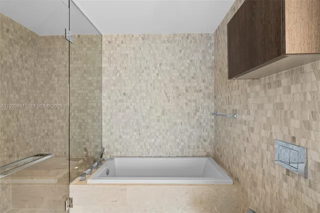 a bathroom with a bathtub and shower