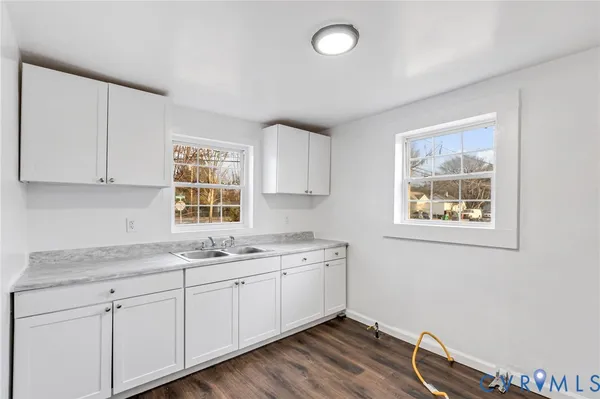 a kitchen with a sink cabinets and window