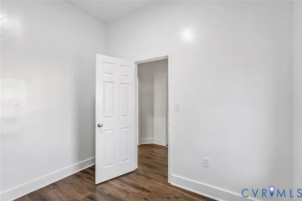 an empty room with wooden floor and closet