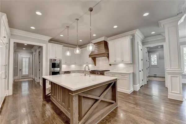a spacious bathroom with a double vanity sink a mirror and a shower