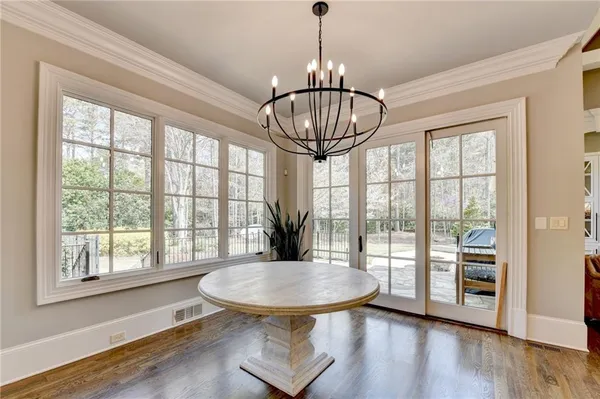 an empty room with ceiling fan and wooden floor