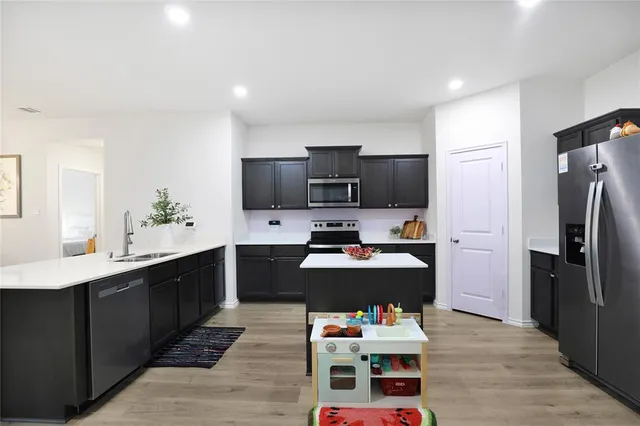 a kitchen with a refrigerator and a sink