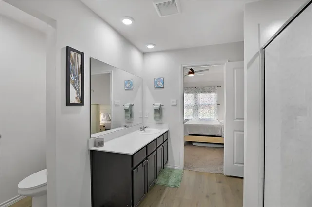 a bathroom with a sink a toilet and mirror