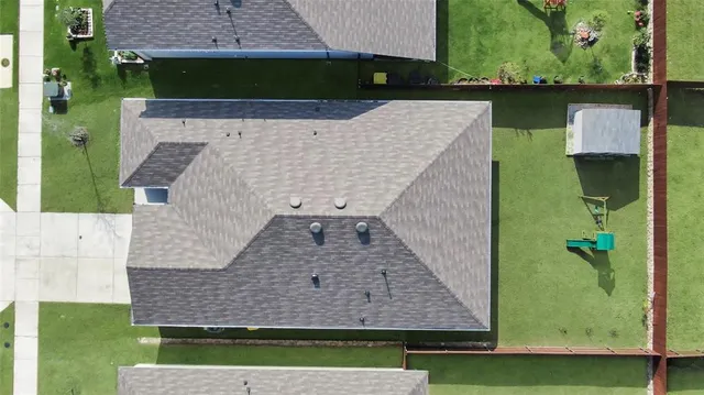 an aerial view of a house with a yard