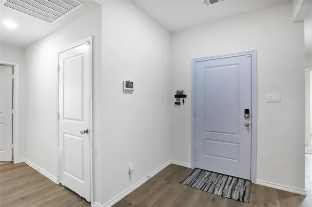 an empty room with wooden floor