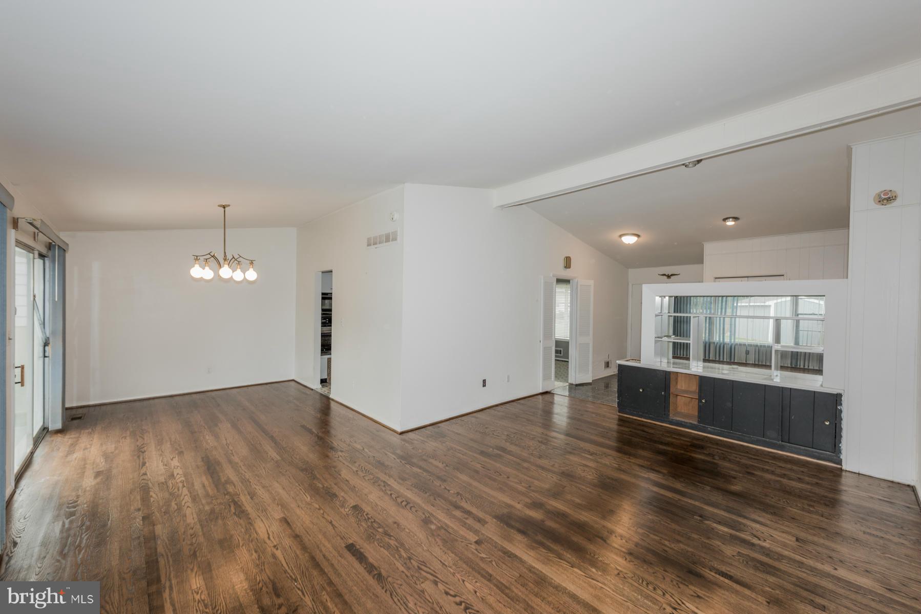 3319 Lauri Road Baltimore, MD 21244 - Photo 2 of 28 an empty room with wooden floor and kitchen view