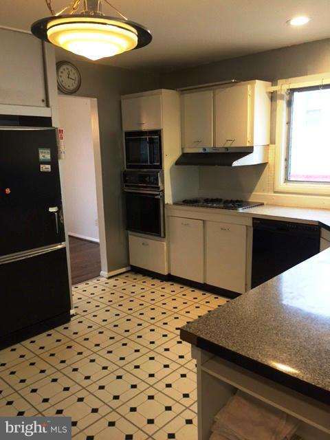 3319 Lauri Road Baltimore, MD 21244 - Photo 11 of 28 a kitchen with a sink a refrigerator and cabinets