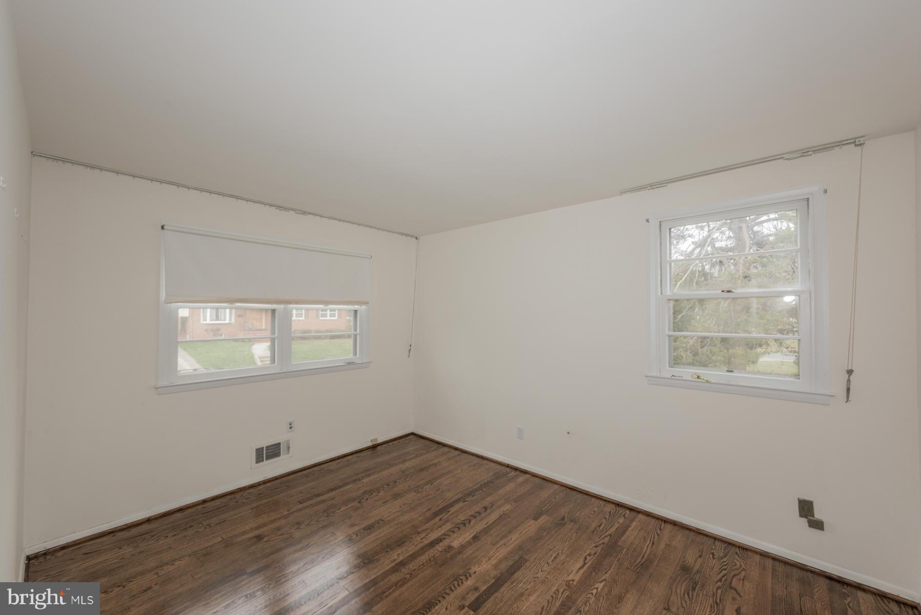 3319 Lauri Road Baltimore, MD 21244 - Photo 17 of 28 an empty room with wooden floor and windows