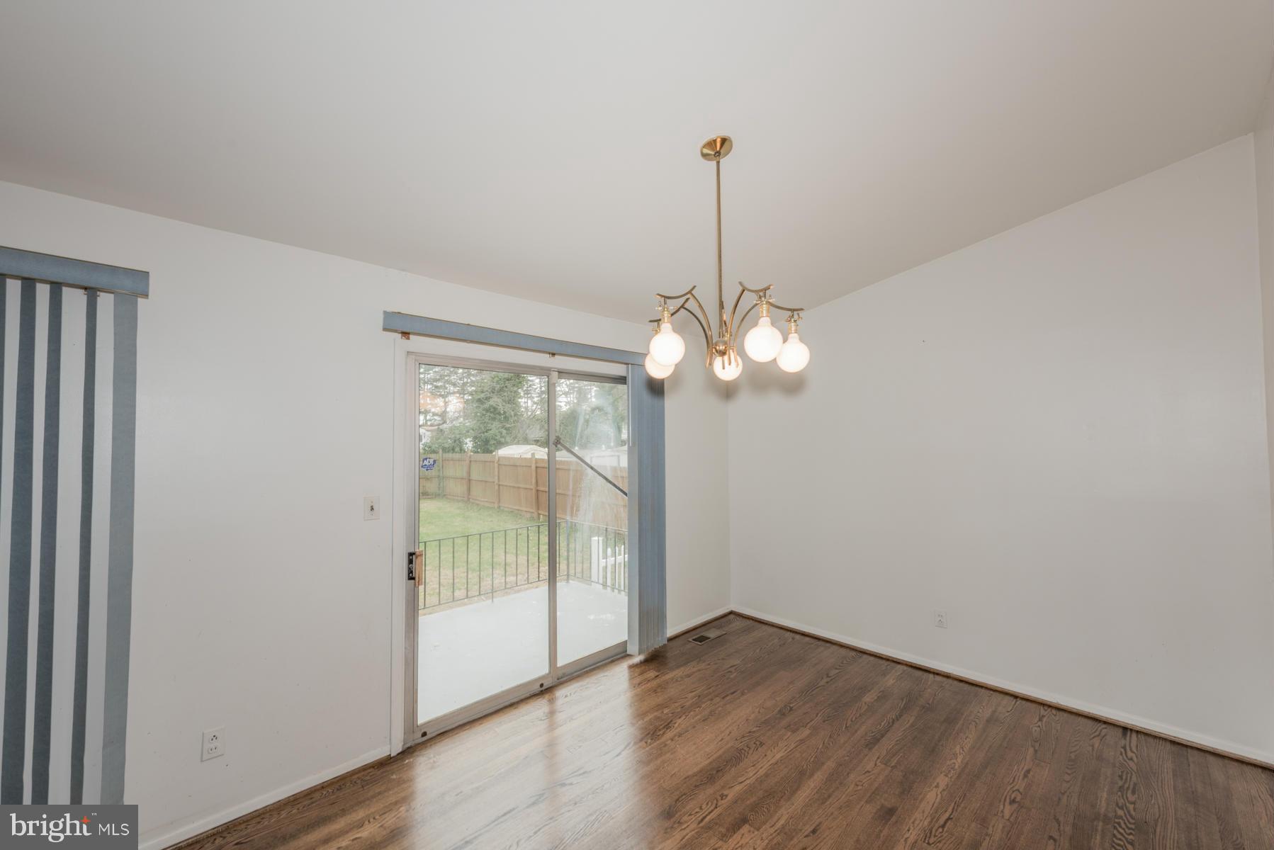 3319 Lauri Road Baltimore, MD 21244 - Photo 7 of 28 a view of a big room with wooden floor and windows
