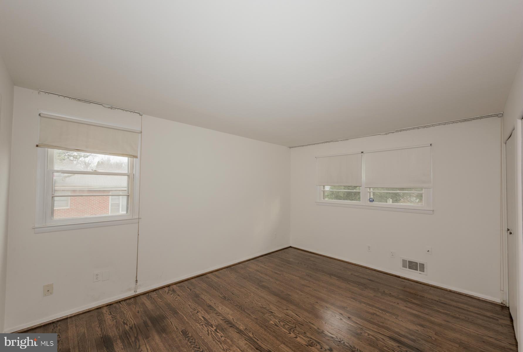 3319 Lauri Road Baltimore, MD 21244 - Photo 8 of 28 an empty room with wooden floor and windows