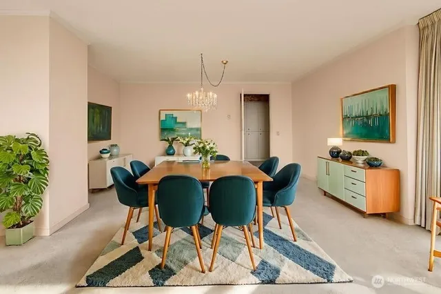 a living room with furniture and a chandelier