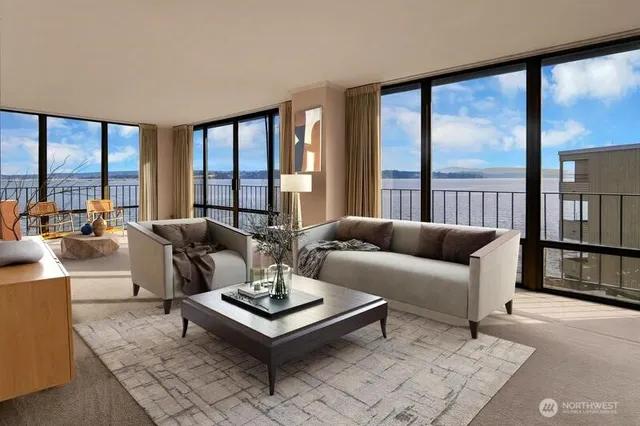 a living room with furniture a table and a large window