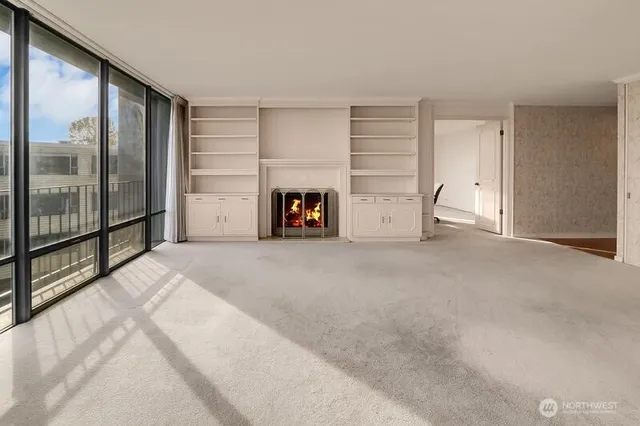 a view of empty room with a fireplace