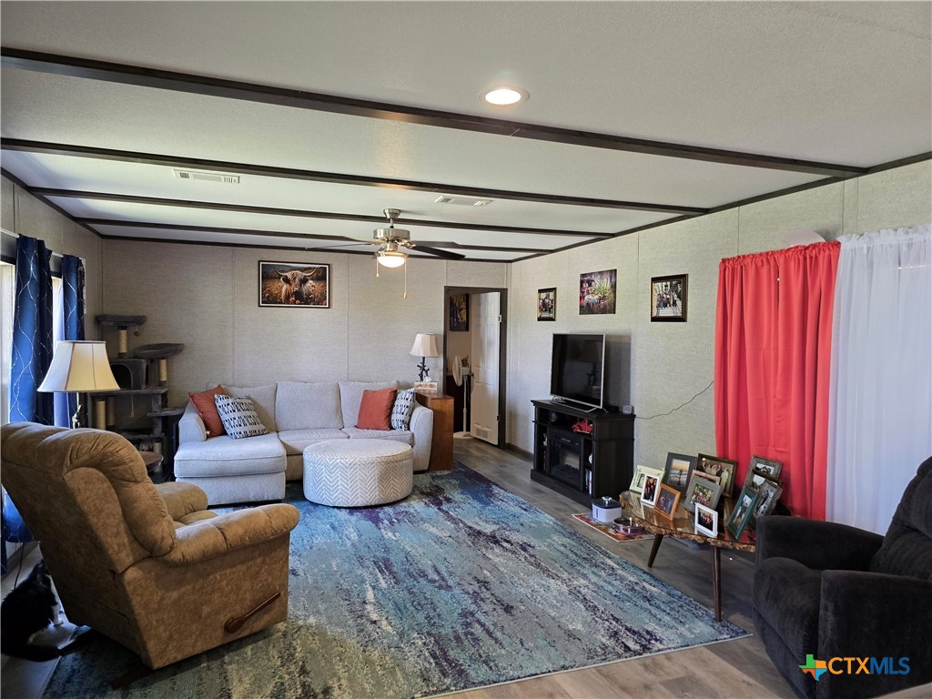 412 Coryell City Road Gatesville, TX 76528 - Photo 4 of 34 a living room with furniture a flat screen tv and a fireplace