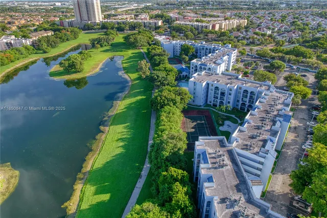 an aerial view of a house with a garden and lake view