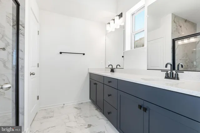 a bathroom with a granite countertop shower