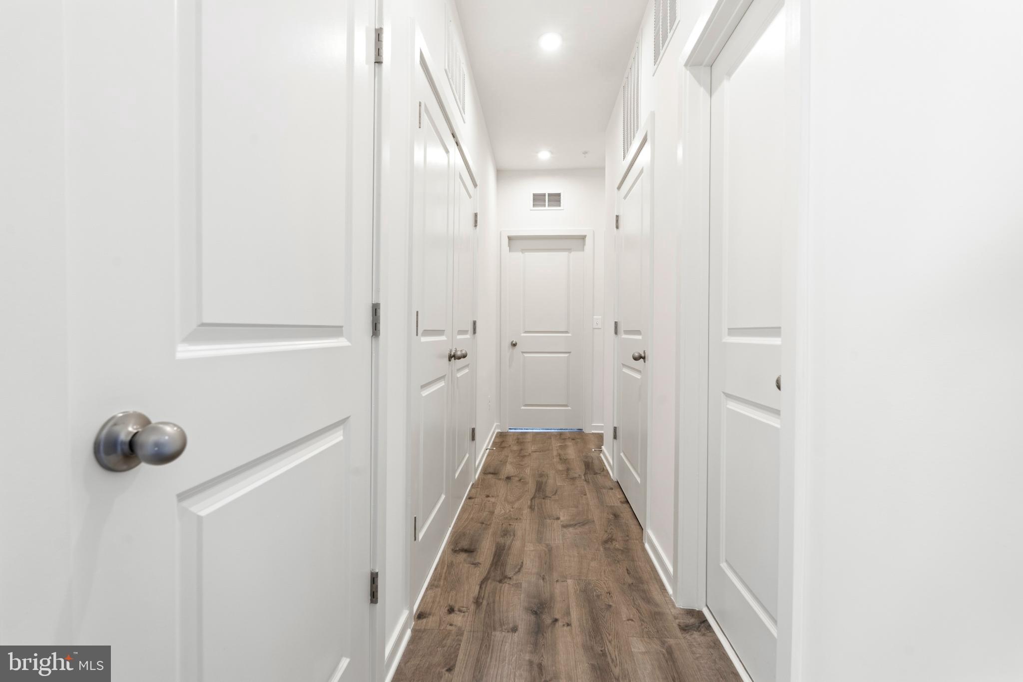 19705 Misty Moss Square Ashburn, VA 20147 - Photo 16 of 25 Bright and inviting hallway with modern doors.