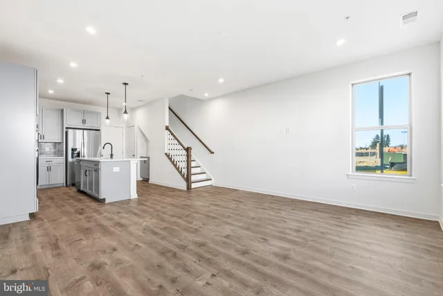 a view of a kitchen with wooden floor