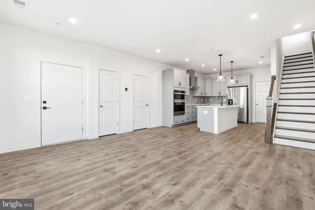 a large kitchen with cabinets a sink dishwasher a stove and a refrigerator