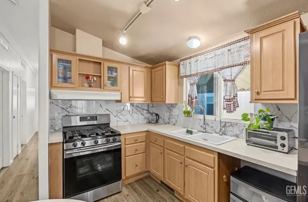 a kitchen with a sink stove and cabinets