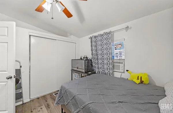 a bedroom with a bed and a window