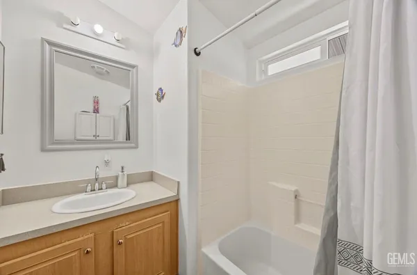 a bathroom with a granite countertop sink toilet and a mirror