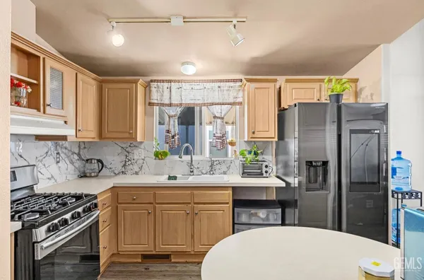 a kitchen with a sink stove and refrigerator