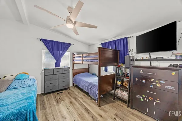 a bedroom with furniture and a flat screen tv