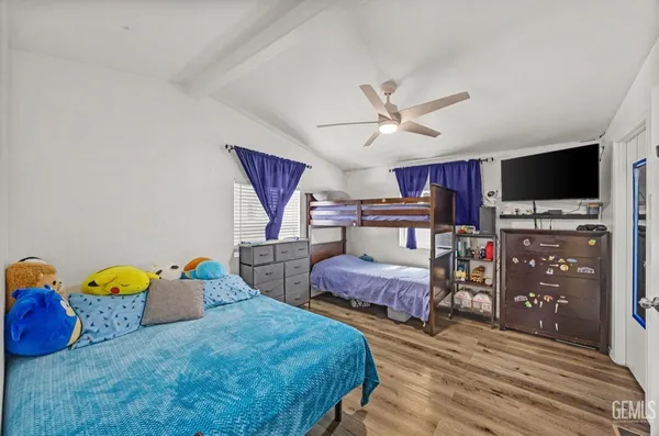 a bedroom with furniture and a flat screen tv
