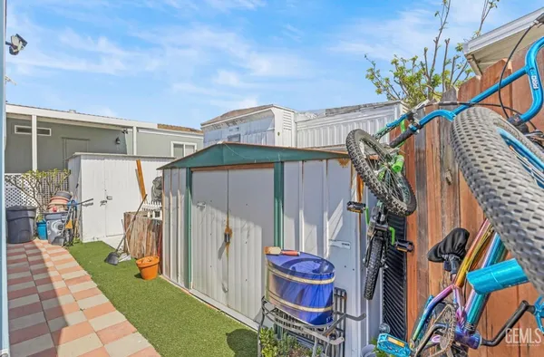 a view of a house with a small yard and wooden fence