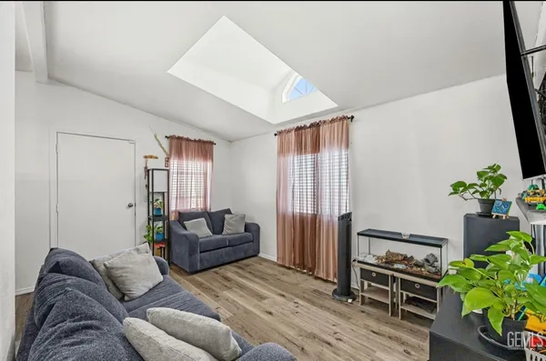 a living room with furniture and a potted plant