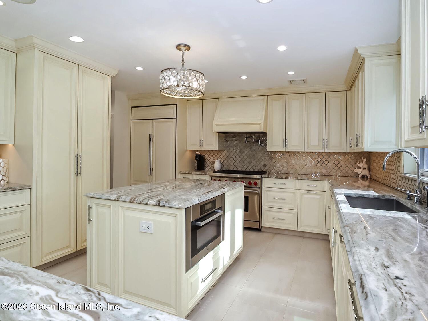 160 Wolverine Street Staten Island, NY 10306 - Photo 12 of 51 a kitchen with a stove sink and cabinets