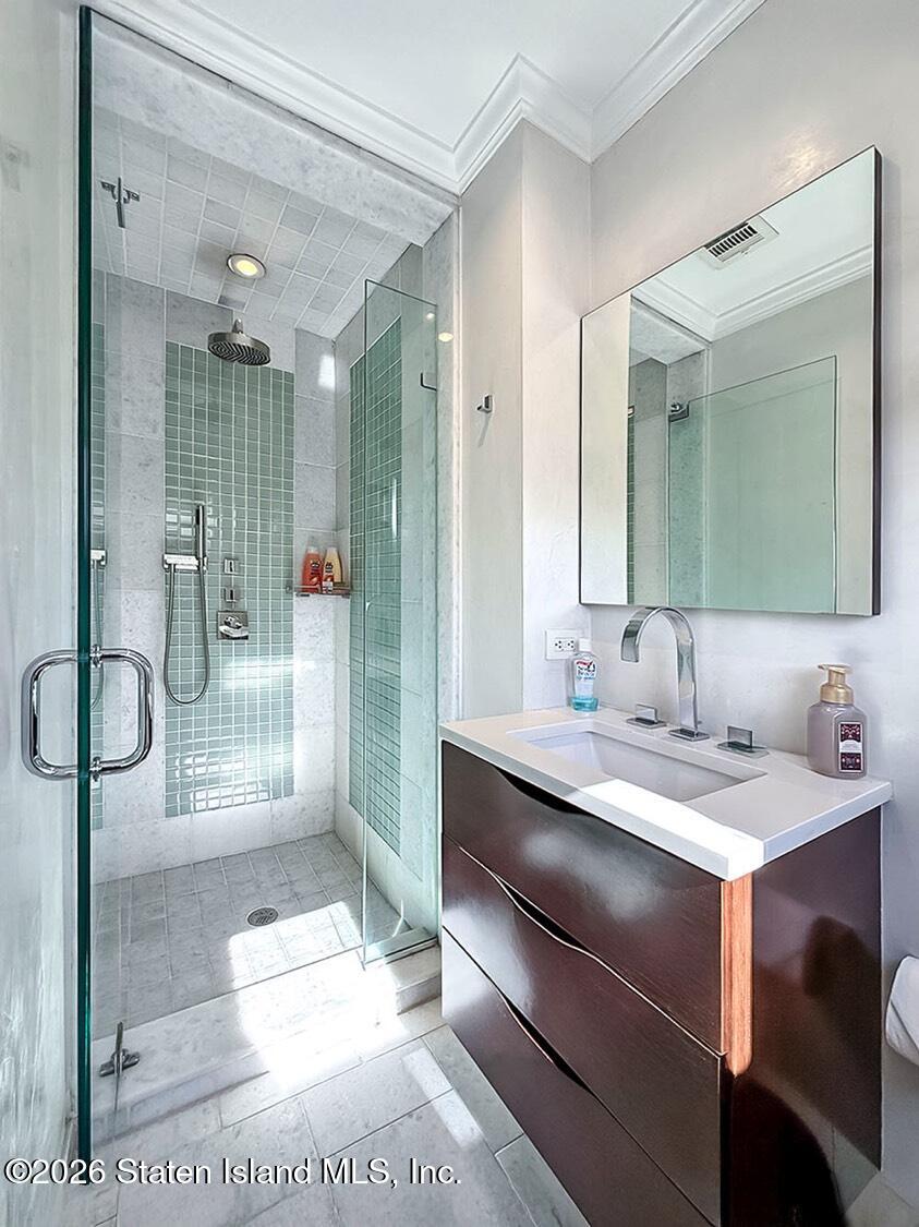 160 Wolverine Street Staten Island, NY 10306 - Photo 24 of 51 a bathroom with a double vanity sink a toilet and a shower