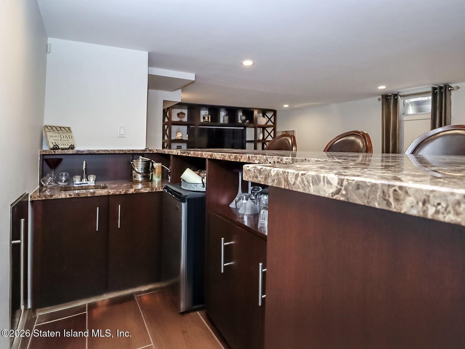 160 Wolverine Street Staten Island, NY 10306 - Photo 36 of 51 a kitchen with stainless steel appliances granite countertop a refrigerator a sink and wooden cabinets