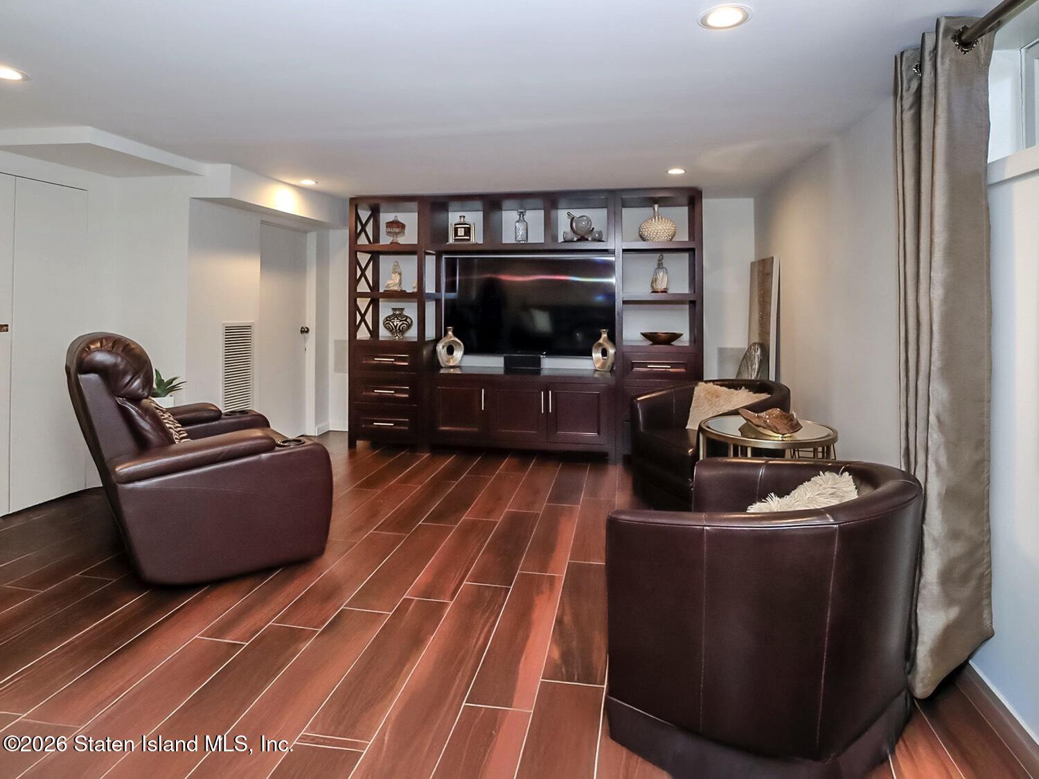 160 Wolverine Street Staten Island, NY 10306 - Photo 38 of 51 a living room with furniture and a flat screen tv