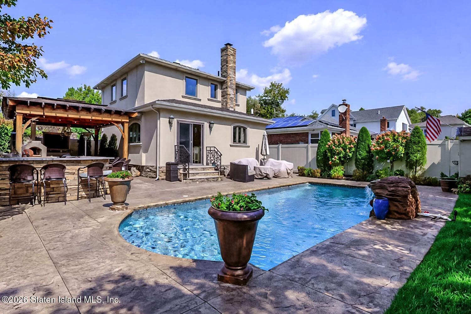 160 Wolverine Street Staten Island, NY 10306 - Photo 40 of 51 a view of a patio with table and chairs potted plants and a large tree