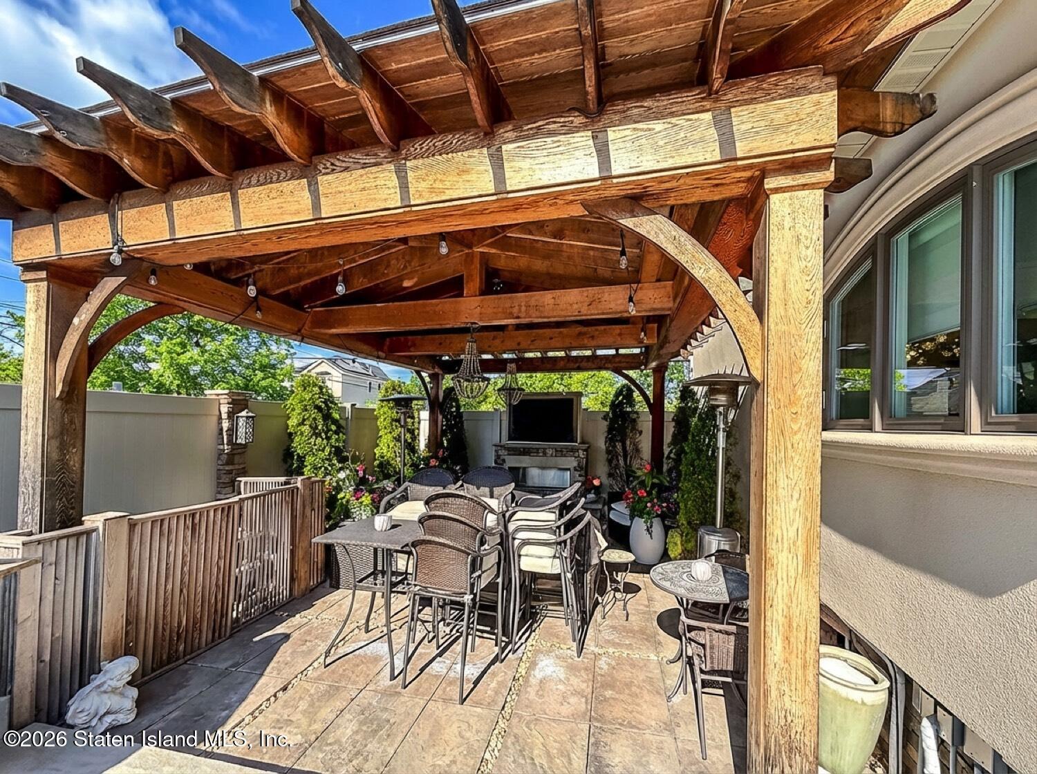 160 Wolverine Street Staten Island, NY 10306 - Photo 43 of 51 a view of a patio with table and chairs and potted plants