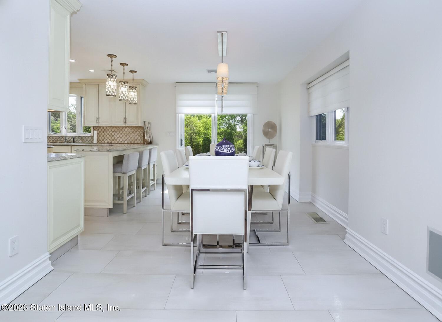 160 Wolverine Street Staten Island, NY 10306 - Photo 8 of 51 a dining room that has a dining table and a chandelier