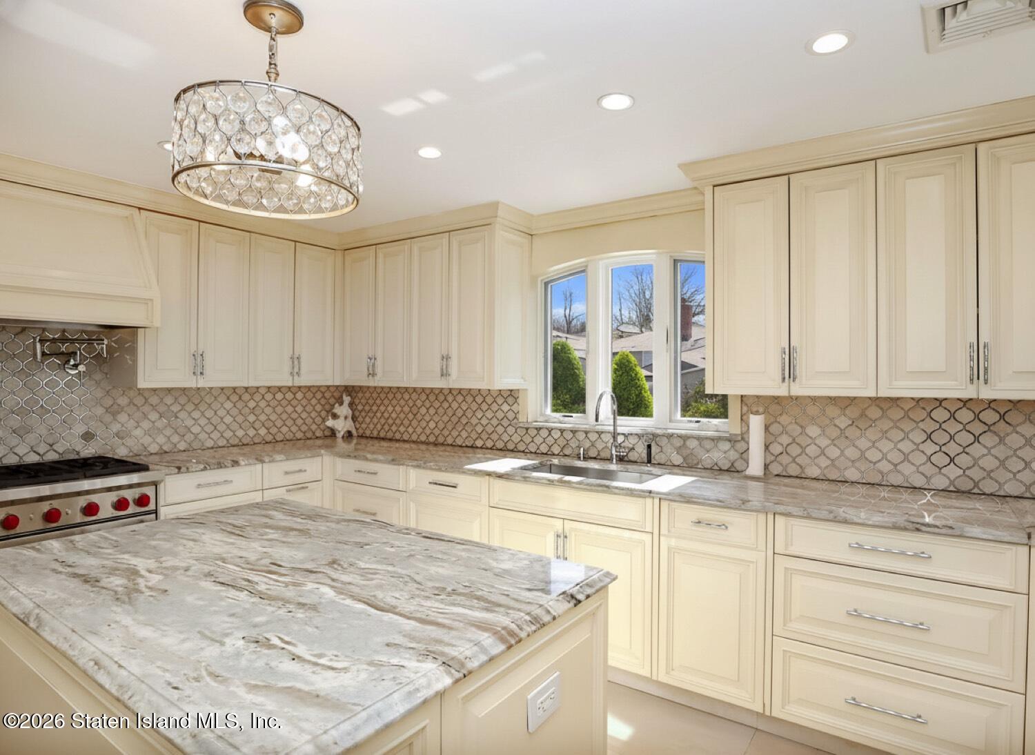 160 Wolverine Street Staten Island, NY 10306 - Photo 10 of 51 a kitchen with stainless steel appliances granite countertop a sink a stove and cabinets
