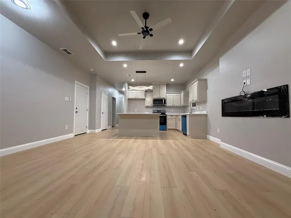 a view of kitchen with sink microwave and stove