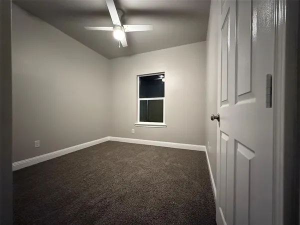 en empty room with windows and closet