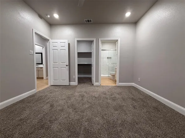 an empty room with closet and bathroom