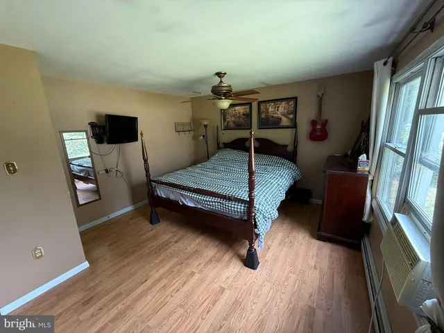 a bedroom with a bed and a mirror