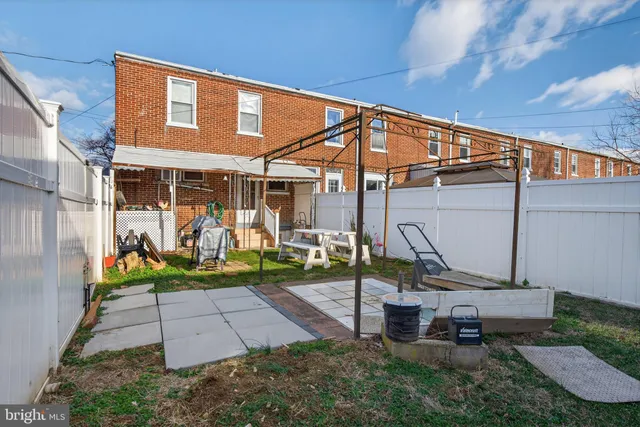a backyard of a house with yard and outdoor seating